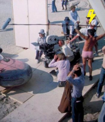 Original 1977 behind-the-scenes photograph of boom operator Ken Nightingall on the Star Wars A New Hope Tunisia set wearing pink shorts and boots