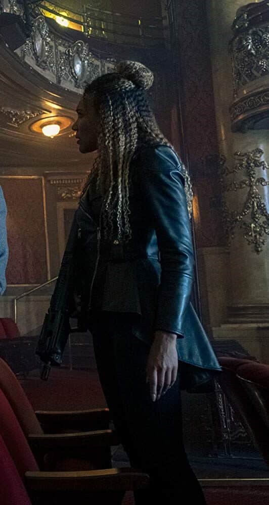 Allison Hargreeves full Halloween costume look from The Umbrella Academy with black leather biker jacket, curly wig, and patent ankle boots, useful as a group costume reference