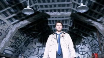Castiel standing with his shadow wings visible on the wall behind him in Supernatural