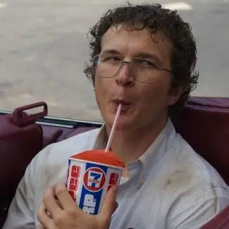 Dr. Alexei from Stranger Things drinking a 7-Eleven Slurpee, one of his signature scenes in America