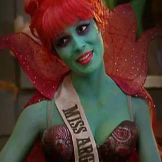 Miss Argentina cosplay styling reference from Beetlejuice showing green skin, red updo, sequined dress and pageant sash
