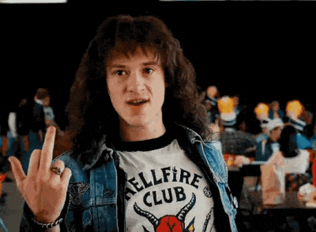 Eddie Munson from Stranger Things giving his iconic middle finger gesture, one of the most recognisable and beloved character moments from the series and a defining expression of the Eddie Munson Halloween costume attitude
