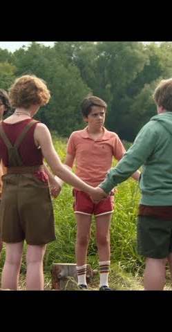 Eddie Kaspbrak Halloween costume reference showing pink polo, brown cargo shorts, fanny pack, arm cast, and blue sneakers with white crew socks