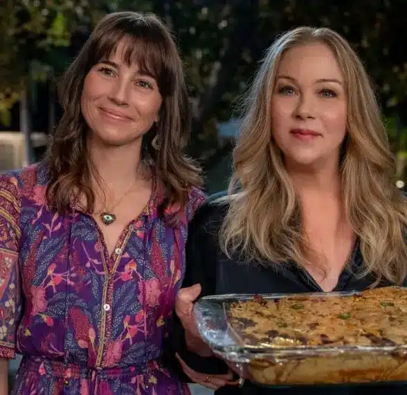 Judy Hale and Jen Harding from Dead to Me together, showing the visual contrast between Judy's warm colorful style and Jen's sharper look, useful reference for the duo outfit idea
