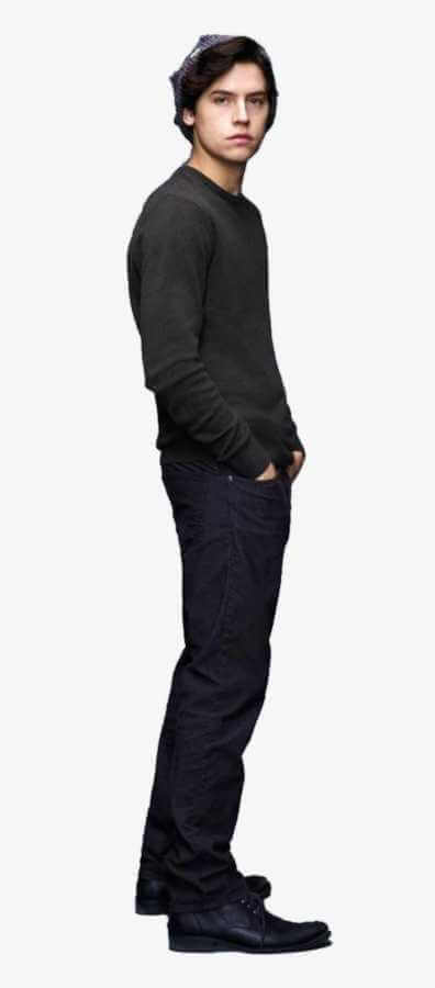 Cole Sprouse as Jughead Jones in Riverdale full body shot wearing grey crown beanie, black denim jacket layered over burgundy sweater, light brown pants, black suspenders, and dark boots