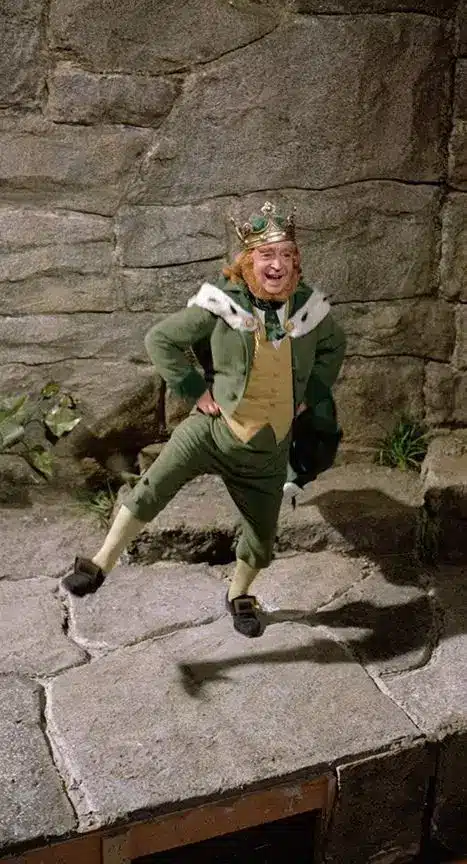 King Brian Connors and Darby O'Gill in the 1959 Disney film, showing the leprechaun king's layered green jacket, fur capelet, crown, and beard