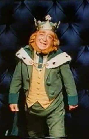 King Brian Connors full body costume reference showing the layered green jacket, fur capelet, crown, and leprechaun beard