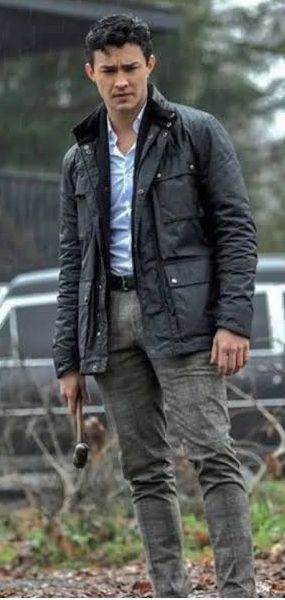 Gavin Leatherwood as Nicholas Scratch in Chilling Adventures of Sabrina, showing the dark coat over dress shirt and tailored trousers that define his Academy of Unseen Arts formal look