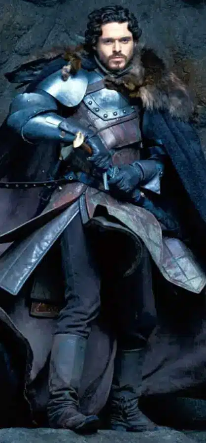 Robb Stark full body cosplay reference showing the King in the North tunic, cape, left shoulder pauldron, and House Stark direwolf pin