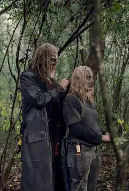 Beta and Alpha standing together in their walker-skin masks in The Walking Dead
