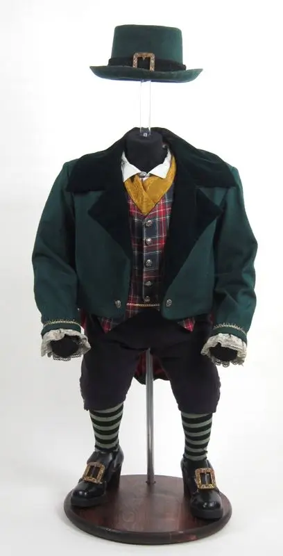 Authentic screen-worn costume elements from the 1993 Leprechaun film showing Lubdan's green tailcoat, plaid vest, and top hat