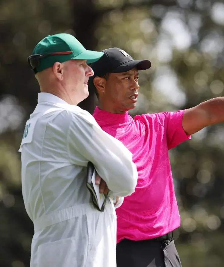 Tiger Woods and caddie Joe LaCava reading a shot on the second hole at Augusta National during the first round of the Masters Tournament