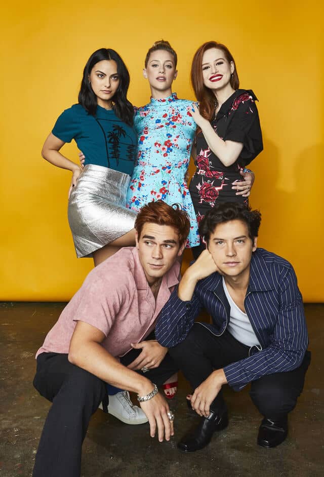 Veronica Lodge, Betty Cooper, Cheryl Blossom, Archie Andrews, and Jughead Jones from Riverdale together showing all five main cast Halloween costume options side by side