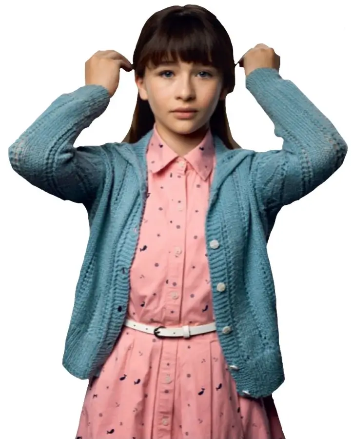 Malina Weissman as Violet Baudelaire in the Netflix series A Series of Unfortunate Events wearing her teal cardigan, pink dress, and blue hair ribbon in her signature inventor look