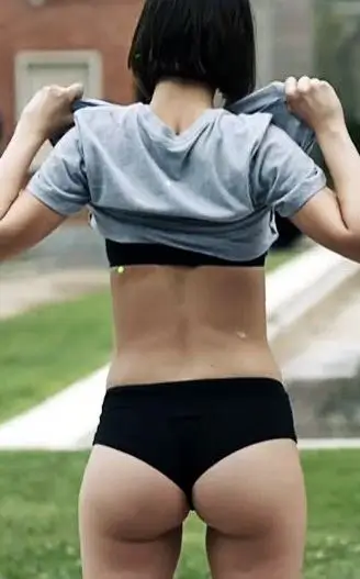 Tokyo from Money Heist standing on the Bank of Spain steps in grey t-shirt and black underwear during the Part 3 surrender scene