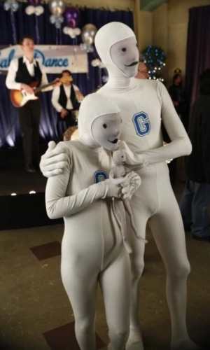 Greendale Human Being mascot costume reference showing the grey bodysuit and drawn on face
