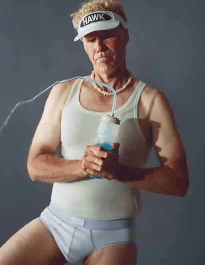 Lonnie Hawkins in the Skims campaign look wearing white briefs, tank top, tube socks, and HAWK patch visor while holding a golf club