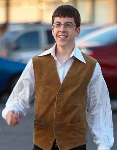 McLovin standing pose costume reference showing vest, oxford shirt, and glasses