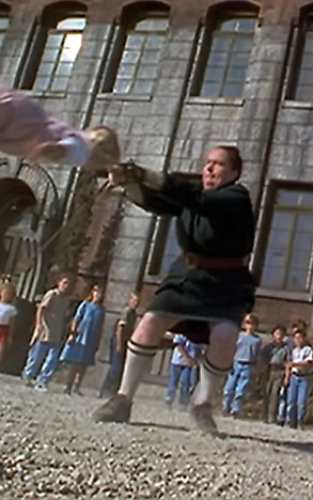 Miss Trunchbull close-up costume reference showing tight bun and stern expression