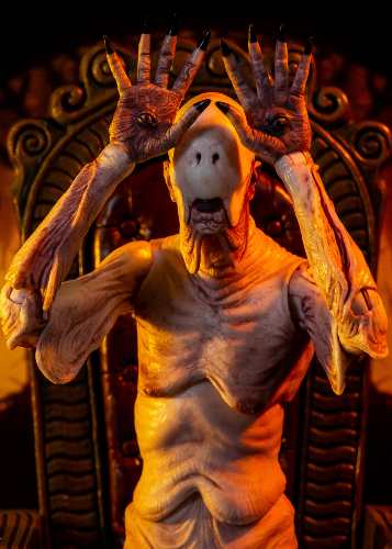 Pale Man from Pan's Labyrinth raising his hands with eyeballs mounted in the palms