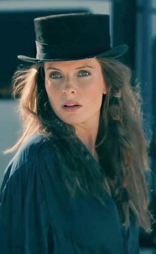 Rose the Hat from Doctor Sleep wearing a floral maxi dress and black top hat, reference photo for the Halloween costume