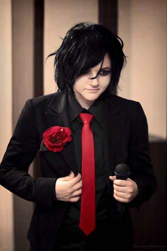 Gerard Way wearing a black suit with red tie and red rose in the Three Cheers for Sweet Revenge era