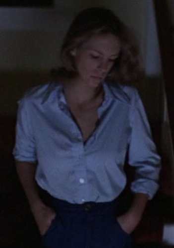 Laurie Strode from Halloween 1978 wearing the blue button-down shirt and flare jeans