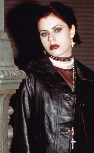 Nancy Downs from The Craft wearing the black leather jacket, the central item in the group and solo costume build
