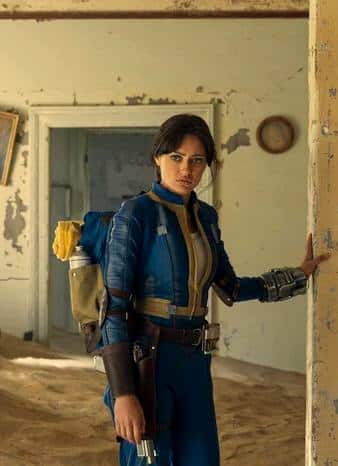 Lucy MacLean from Fallout posed in the wasteland wearing the Vault 33 jumpsuit and leather gear, reference image for the Halloween costume