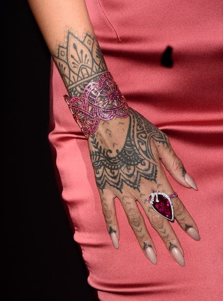 Rihanna's detailed henna-style mandala tattoo covering the back of her right hand and wrapping around her wrist