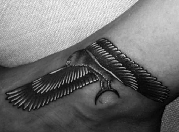 Rihanna's Egyptian falcon tattoo with spread wings on her ankle and the top of her foot