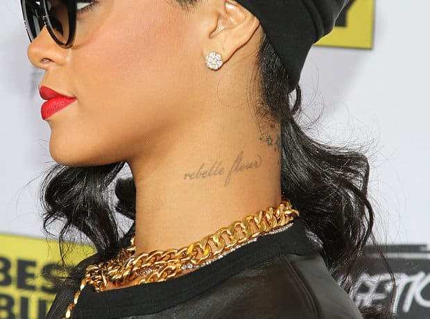 Rihanna's French script tattoo reading Rebelle Fleur on the left side of her neck