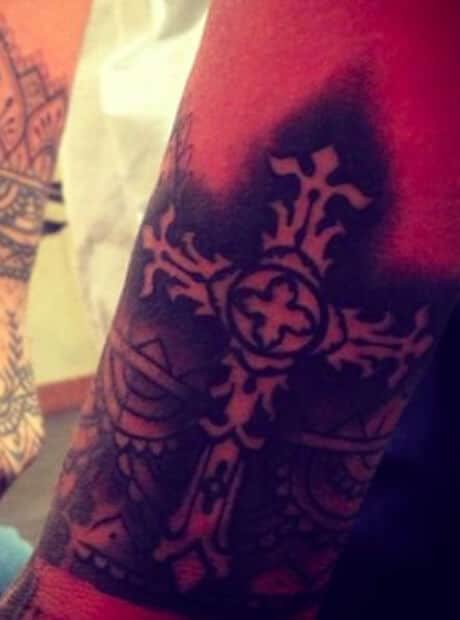 Ornate gothic cross tattoo on the inside of Rihanna's right wrist