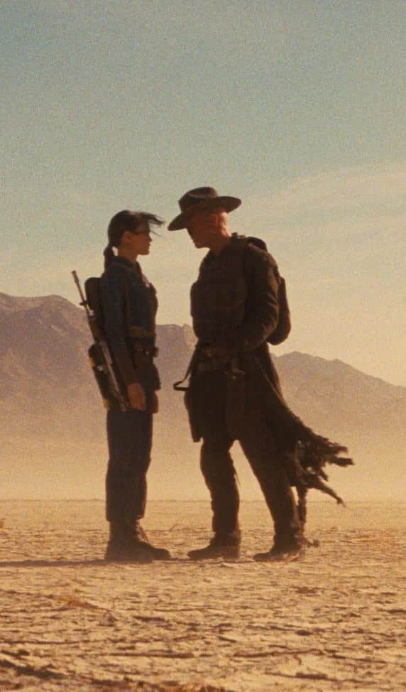 The Ghoul from Fallout standing in a desert standoff pose in his duster coat and cowboy hat, reference for the Halloween costume