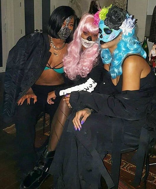 Rihanna in a blue wig and Day of the Dead sugar skull makeup at a 2015 Halloween party