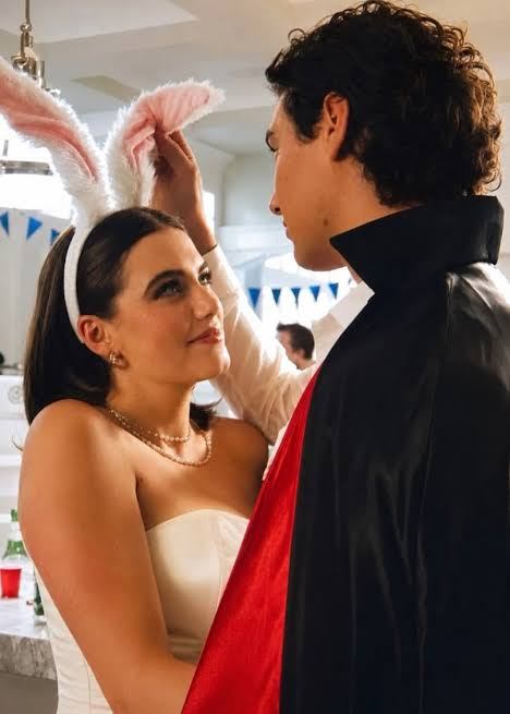 Garrett Graham from Off Campus in a cape and white shirt next to Hannah Wells, couples reference image for the Halloween costume