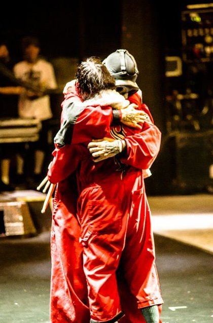 Joey Jordison with other Slipknot members in red coveralls and masks, group reference for the Halloween costume