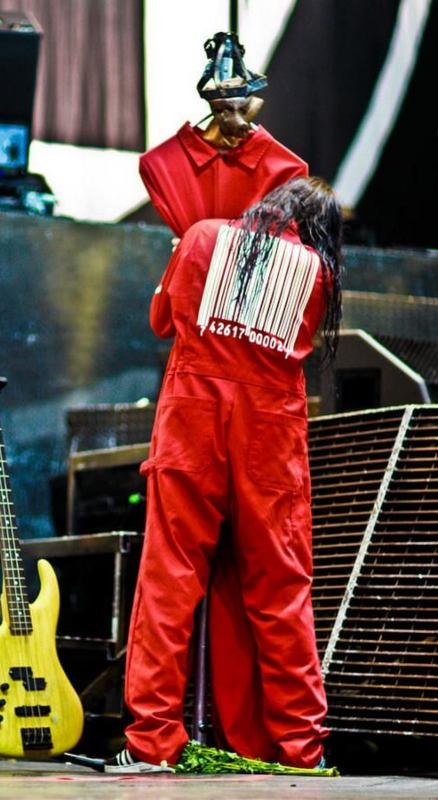 Joey Jordison from Slipknot in a red coverall with a white kabuki-style mask and long black hair, reference image for the Halloween costume